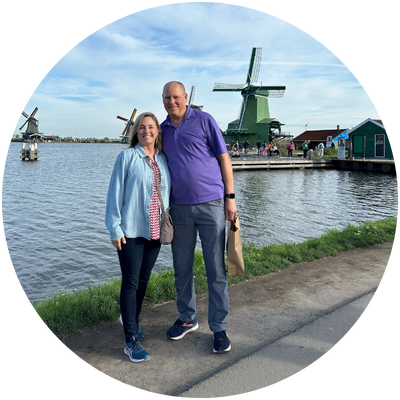 Author byline image. Two people standing together in front of windmills