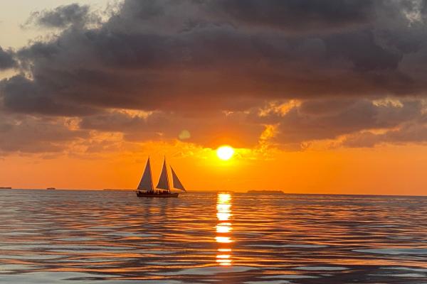 Rving to the Florida Keys. A picture of a sailboat at sunset.