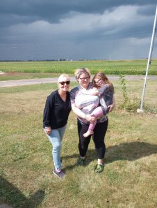 Two women. One holding a little girl